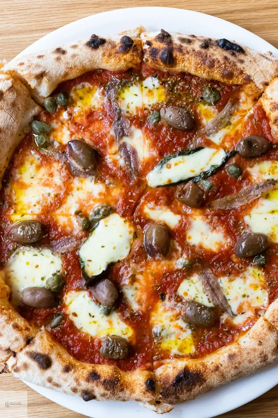 Bel Fiore Pizza Catering Mediterranean — wood-fired Neapolitan pizza with Kalamata olives, capers, anchovies and fior di latte on San Marzano base, Sydney catering events