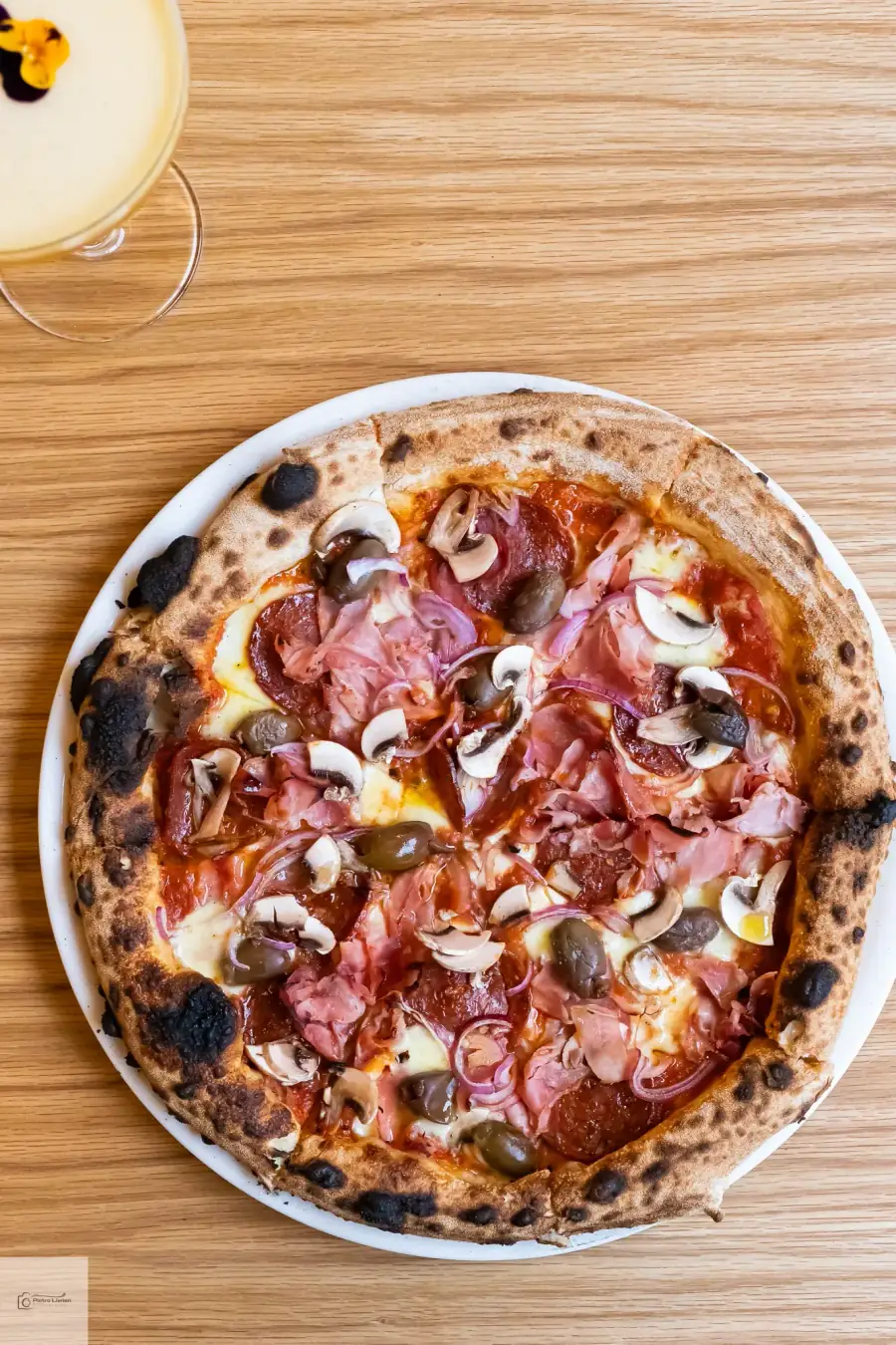 Bel Fiore Pizza Catering capricciosa with prosciutto cotto, salami, mushrooms and Kalamata olives on a wood-fired Neapolitan base — Sydney events