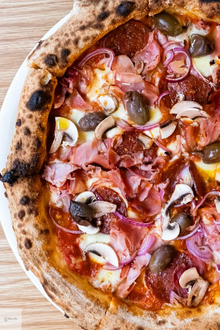 Bel Fiore Pizza Catering capricciosa — prosciutto cotto, salami, mushrooms and Kalamata olives on a wood-fired Neapolitan base, Sydney pizza catering